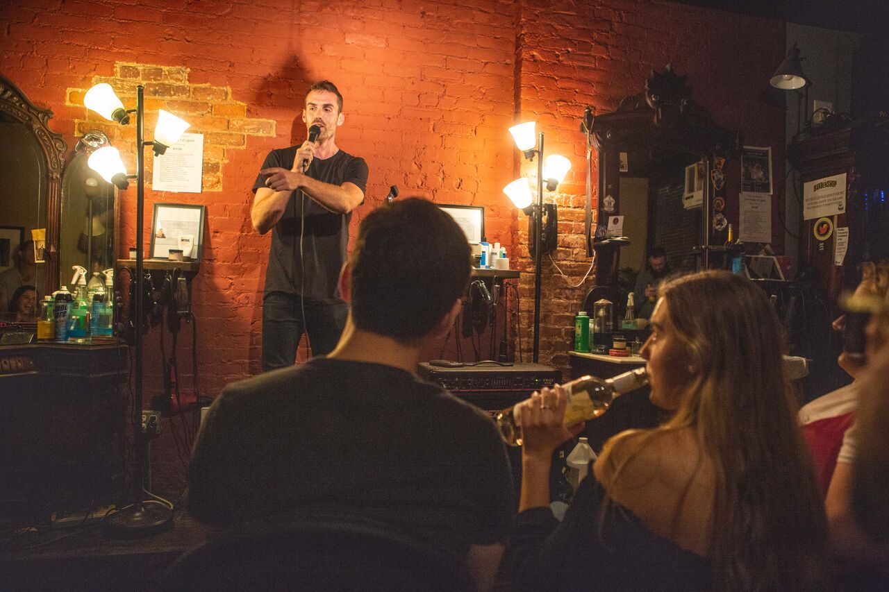 Comedian performing stand-up at Live at the Barbershop in the East Village