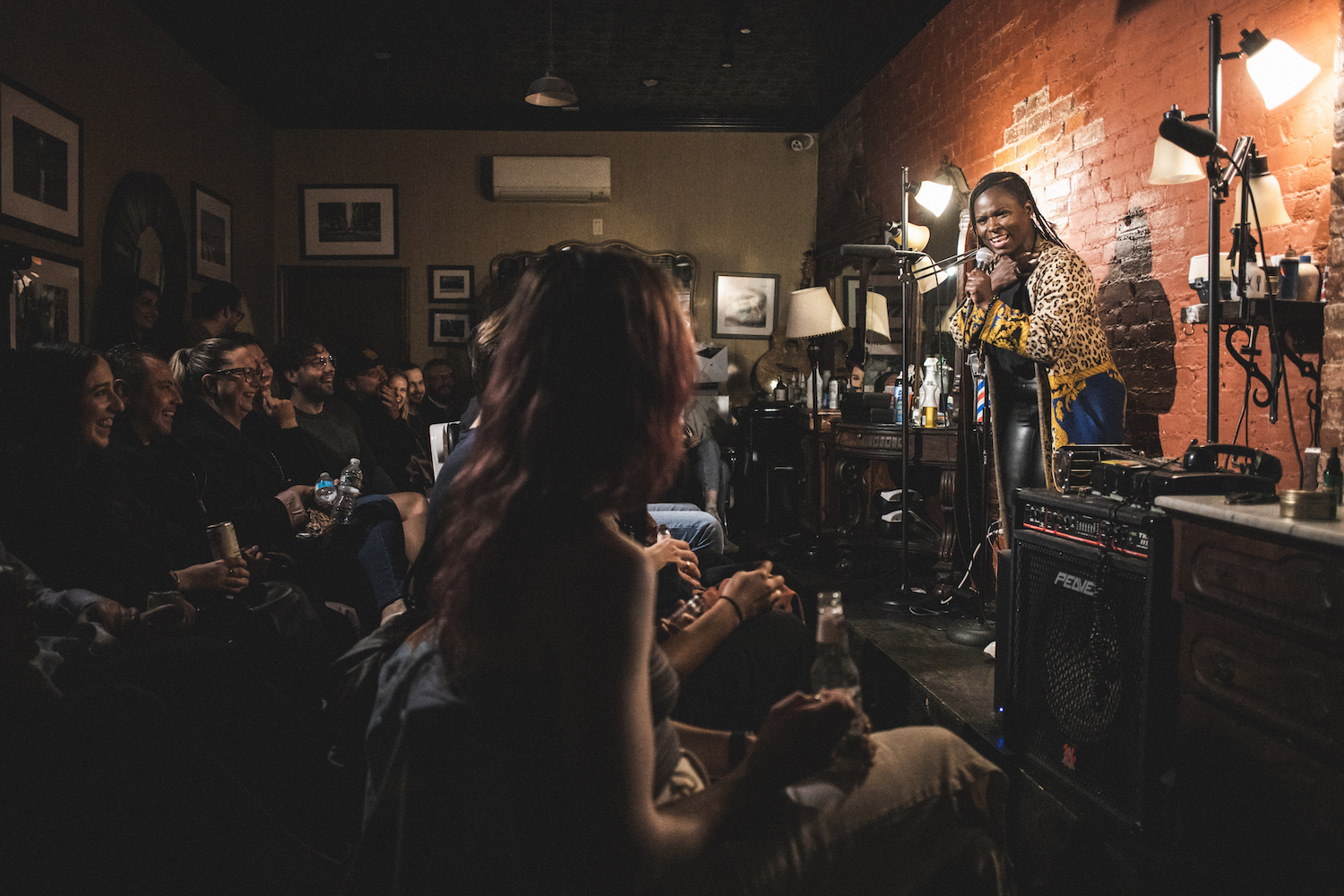 NYC comedian performing for a packed East Village comedy club audience